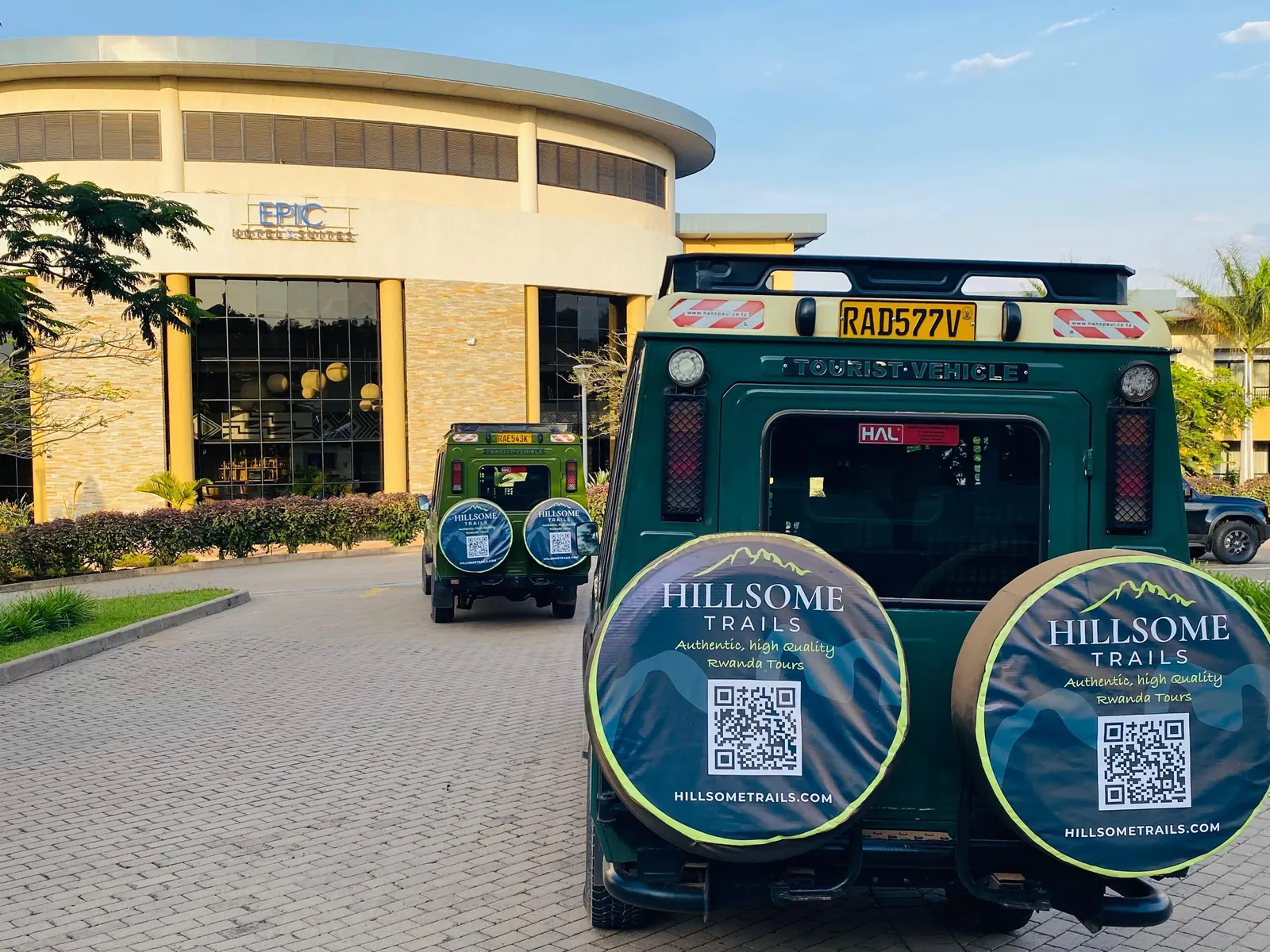 Hillsome Trails safari vehicles parked outside a building